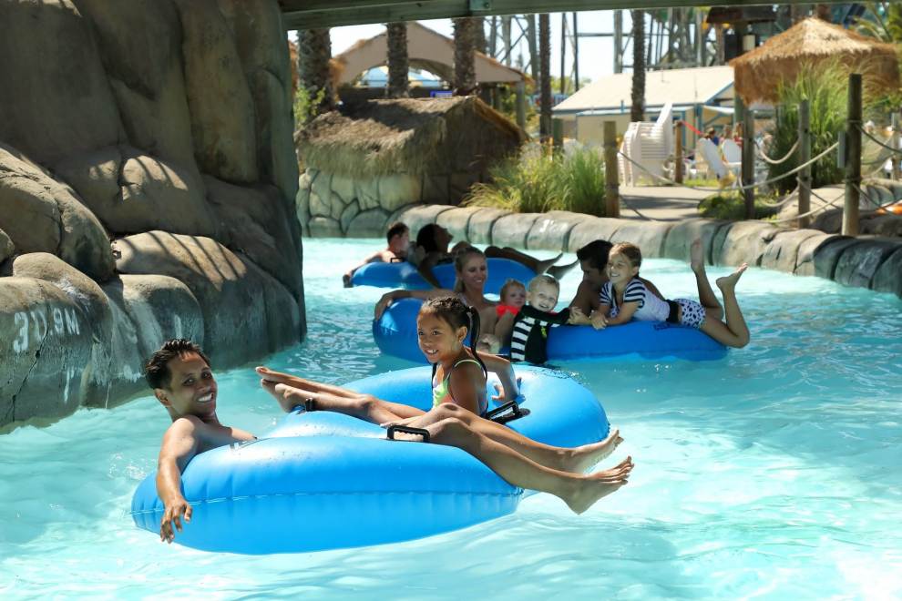 Family floating on blue tubes down a lazy river at Hurricane Harbor waterpark concord ca