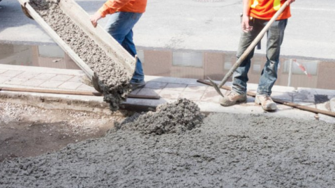 construction workers pouring cement