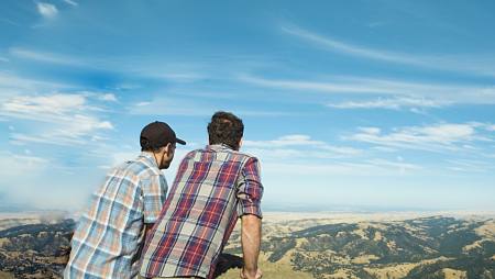 Two men looking out on a scenic landscape from high above in Concord CA