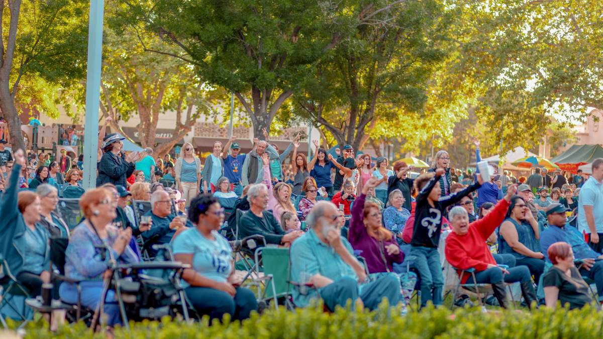 Crowd of people enjoy an outdoor performance in Concord, CA