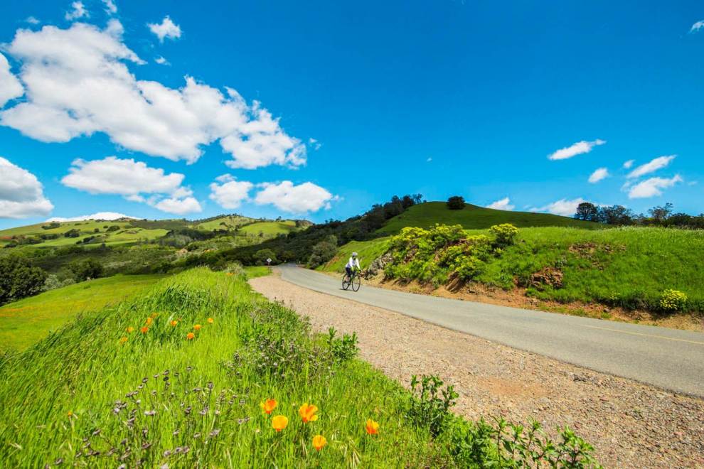 cyclist riding bike on mountain road