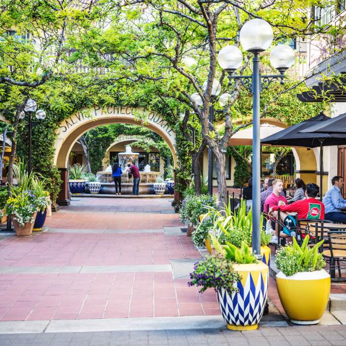 Outdoor plaza with a water fountain in the background