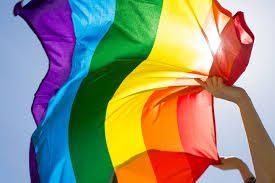 Rainbow Pride flag waving in the wind held in the sky in Concord CA